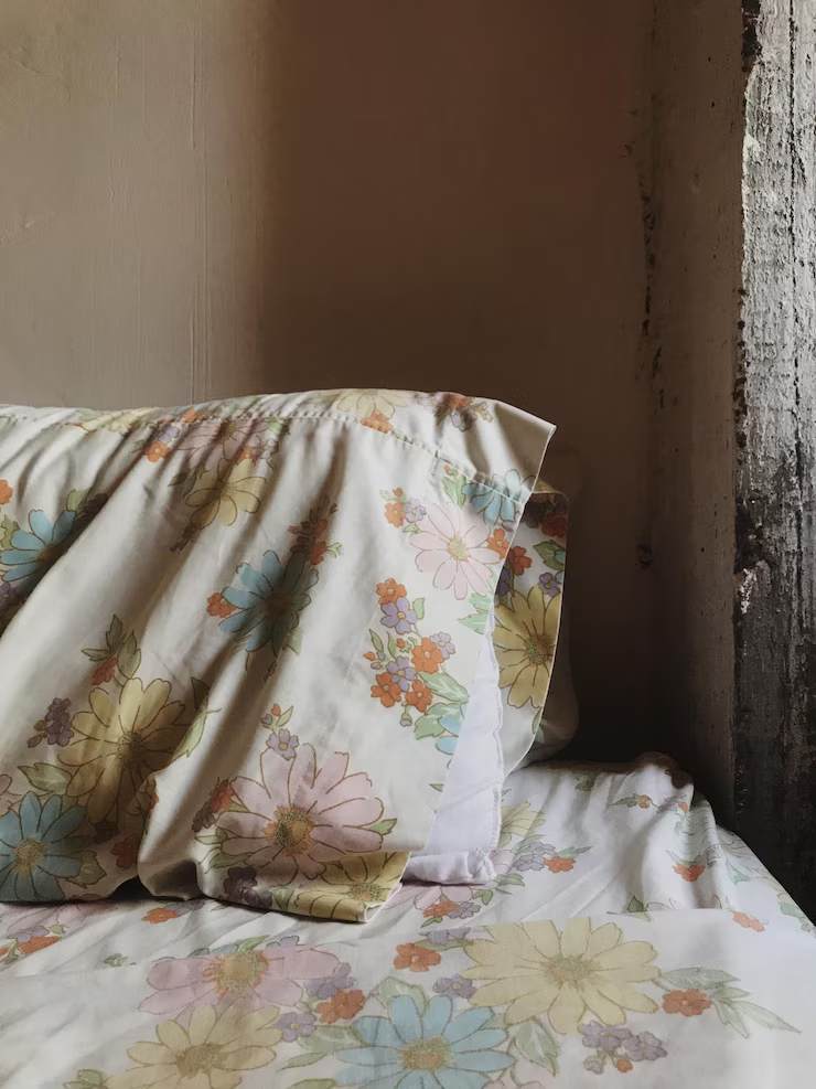Pillow on bed against wall at home